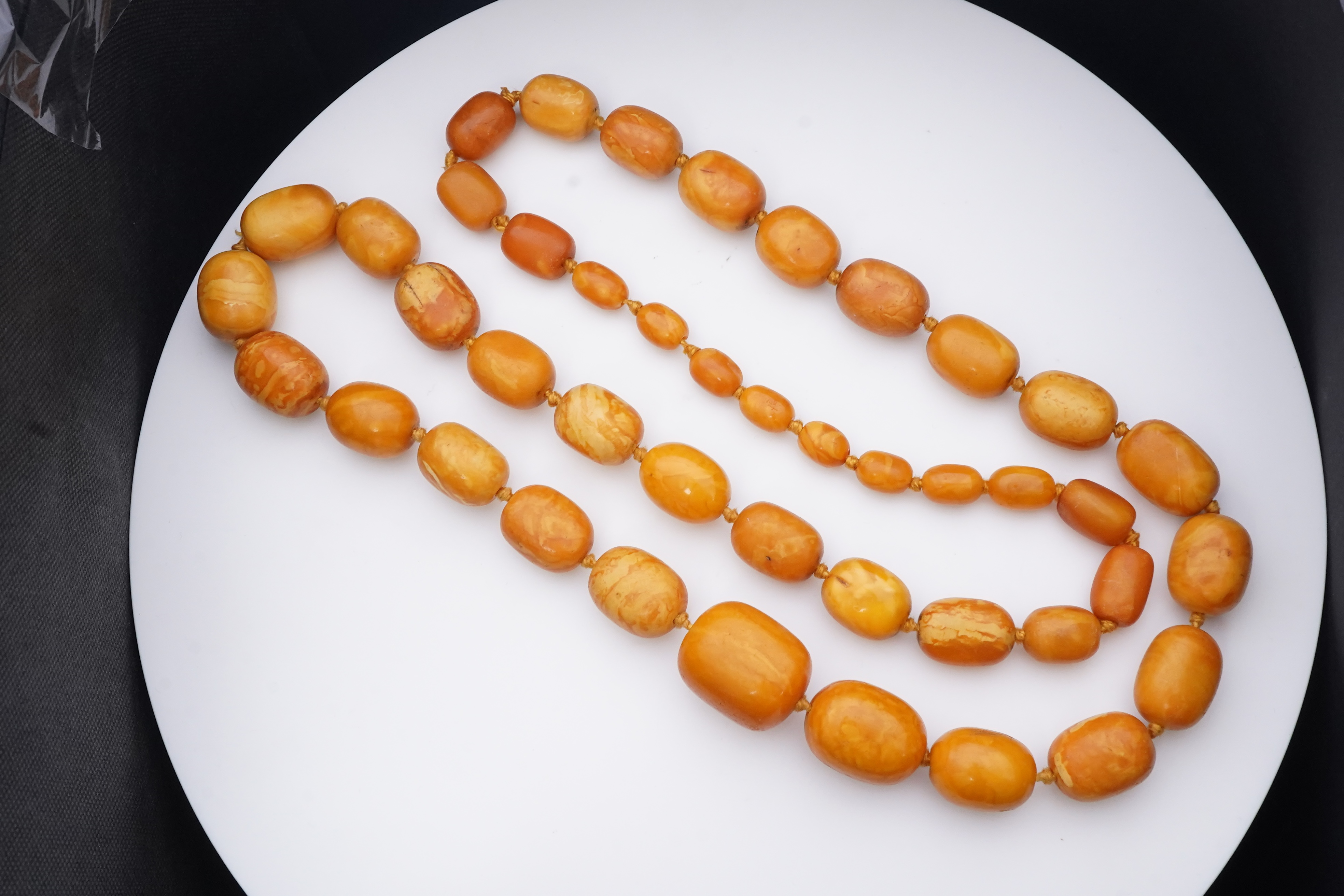 A single strand graduated oval amber bead necklace